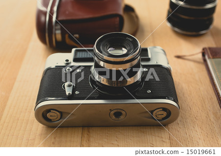 retro camera with portrait lens lying on wooden retro camera with portrait lens lying on wooden 15019661
