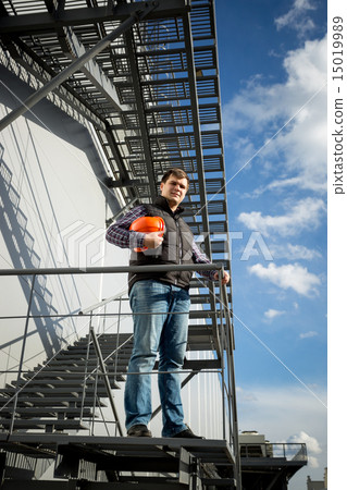 architect standing on metal staircase on side of the factory 15019989