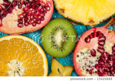 Colorful fruit slices on blue wood surface 15020884