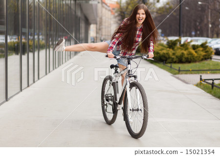 Young beautiful woman on a bicycle 15021354