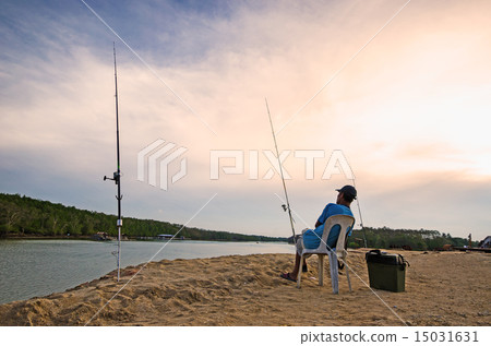 Man sits on a chair and wait for fish Man sits on a chair and wait for fish 15031631