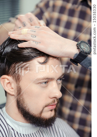 Man makes a haircut at barbershop Man makes a haircut at barbershop 15038330