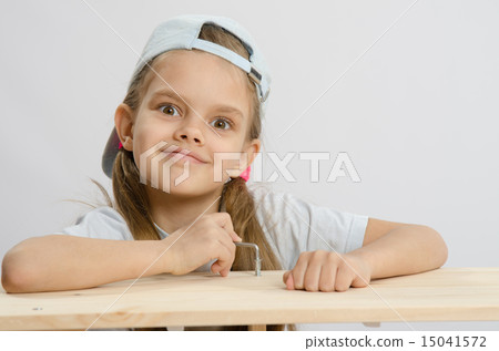 Girl likes to twist the screw with an Allen key 15041572