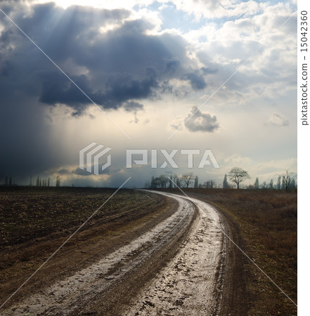 dramatic sky over field with dirty road dramatic sky over field with dirty road 15042360
