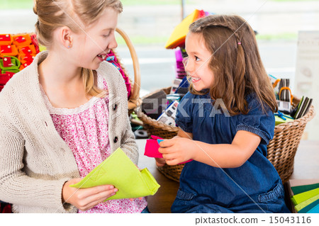 Kids buying supplies  in handicraft store 15043116
