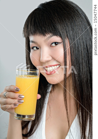 asian woman drinking orange juice 15047744