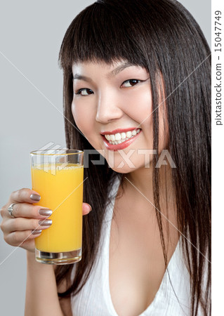 asian woman drinking orange juice 15047749