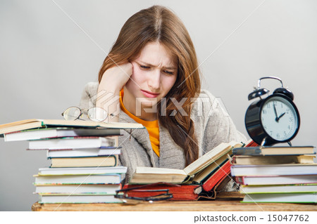 girl student with glasses reading books 15047762