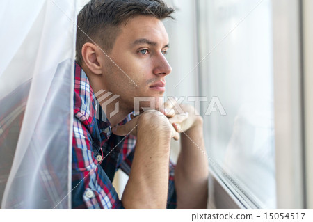 Handsome pensive man guy watching through the window concept sadness sorrow pain waiting 15054517