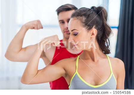 Active athletic sportive woman girl and man showing their muscles biceps healthy lifestyle 15054586