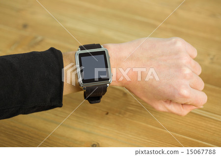 Businesswoman with smart watch on wrist Businesswoman with smart watch on wrist 15067788