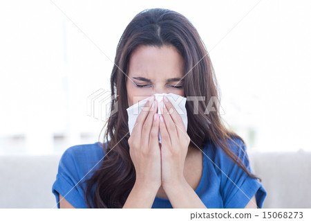 Sick brunette blowing her nose 15068273