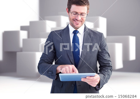 Composite image of businessman using his tablet pc Composite image of businessman using his tablet pc 15068284