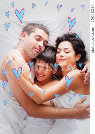 Composite image of happy family lying in bed Composite image of happy family lying in bed 15068286