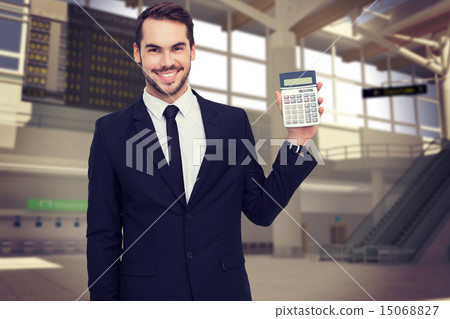 Composite image of smiling businessman presenting a calculator Composite image of smiling businessman presenting a calculator 15068827