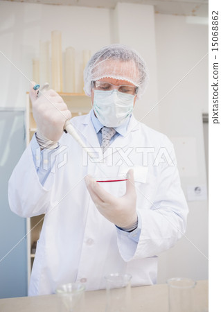 Scientist doing experimentations in petri dish Scientist doing experimentations in petri dish 15068862