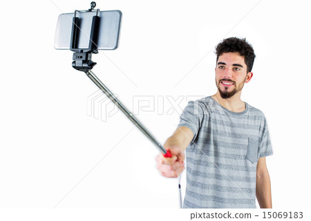 Casual man using a selfie stick 15069183