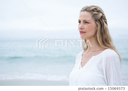 Smiling blonde standing by the sea Smiling blonde standing by the sea 15069373