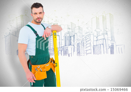 Composite image of carpenter smiling to camera with spirit level 15069466