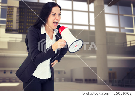 Composite image of pretty businesswoman shouting with megaphone 15069702