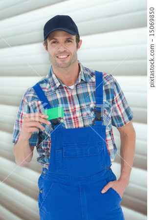 Composite image of confident plumber showing green card Composite image of confident plumber showing green card 15069850