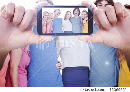 Composite image of hand holding smartphone showing 15069851