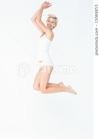 Cheerful blonde woman jumping Cheerful blonde woman jumping 15069853
