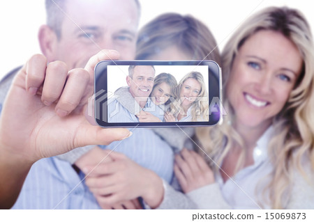 Composite image of hand holding smartphone showing 15069873