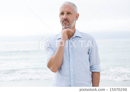 Thoughtful man standing by the sea 15070298