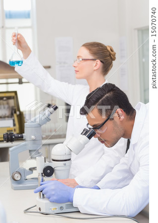 Scientists examining blue precipitate 15070740