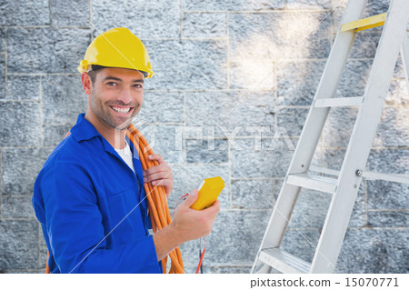 Composite image of smiling male electrician holding multimeter i 15070771