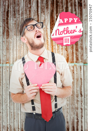 Composite image of geeky hipster crying and holding heart card Composite image of geeky hipster crying and holding heart card 15070947