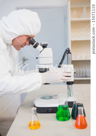 Scientist examining sample with microscope 15071119