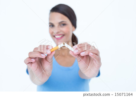 Happy woman breaking a cigarette Happy woman breaking a cigarette 15071164