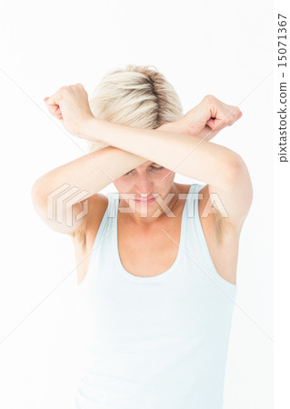 Upset woman holding her arms in front of her head 15071367