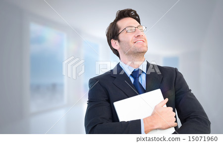 Composite image of handsome businessman holding his laptop Composite image of handsome businessman holding his laptop 15071960