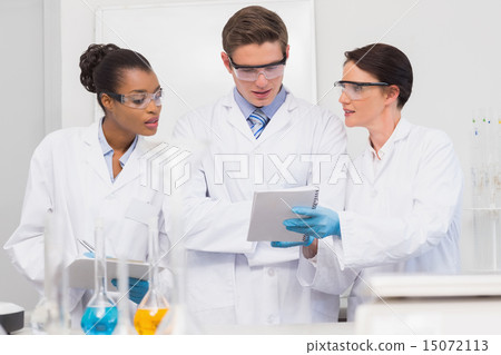 Scientists looking at clipboard Scientists looking at clipboard 15072113