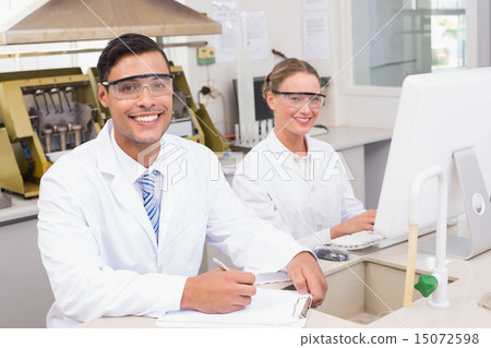 Smiling scientists looking at camera Smiling scientists looking at camera 15072598