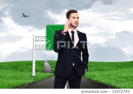 Composite image of serious businessman hand in pocket phoning 15072743