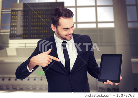 Composite image of happy businessman pointing with his tablet Composite image of happy businessman pointing with his tablet 15072768