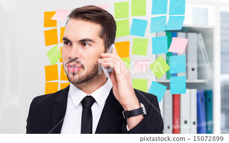 Composite image of smart businessman speaking on the phone 15072899