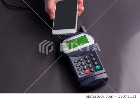 Man using smartphone to express pay Man using smartphone to express pay 15073111