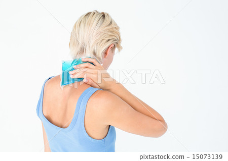 Blonde woman putting gel pack on neck Blonde woman putting gel pack on neck 15073139