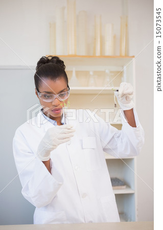 Scientist looking at sprouts in test tube Scientist looking at sprouts in test tube 15073545