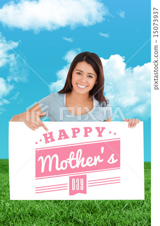 Composite image of beautiful woman pointing at a board 15073937