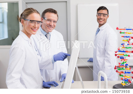 Smiling scientist working with computer 15073938