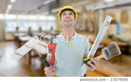 Composite image of worker holding various equipment over white b 15074000