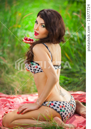 sensual girl with red lips playing cherry, pin-up retro style 15077724