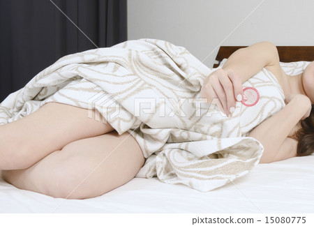 A hand of a young woman with a condom 15080775