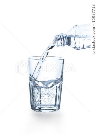 Pouring water into glass on white background Pouring water into glass on white background 15087718